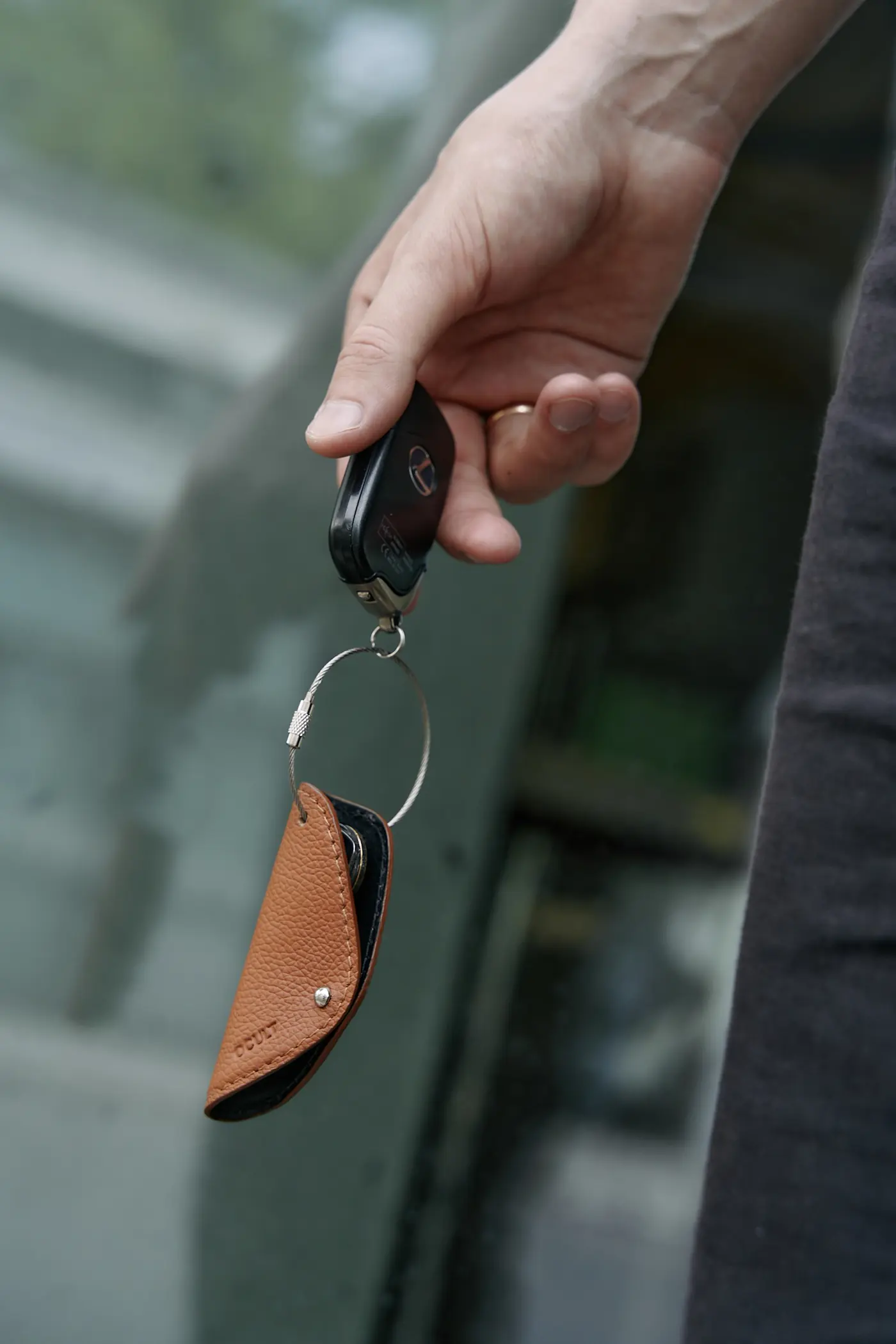 Vehicle key fob with a leather holder
