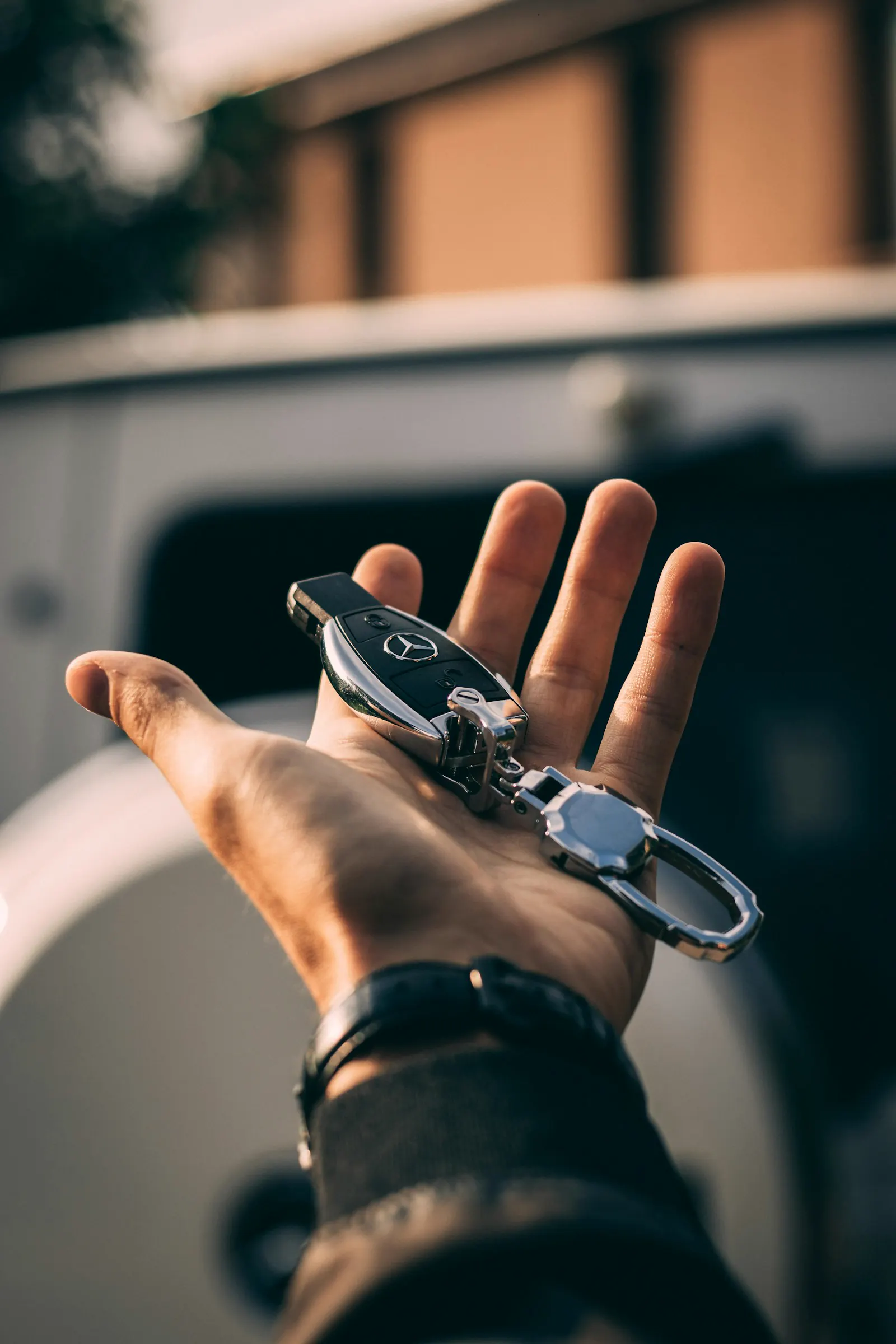 Hand holding a modern vehicle key fob