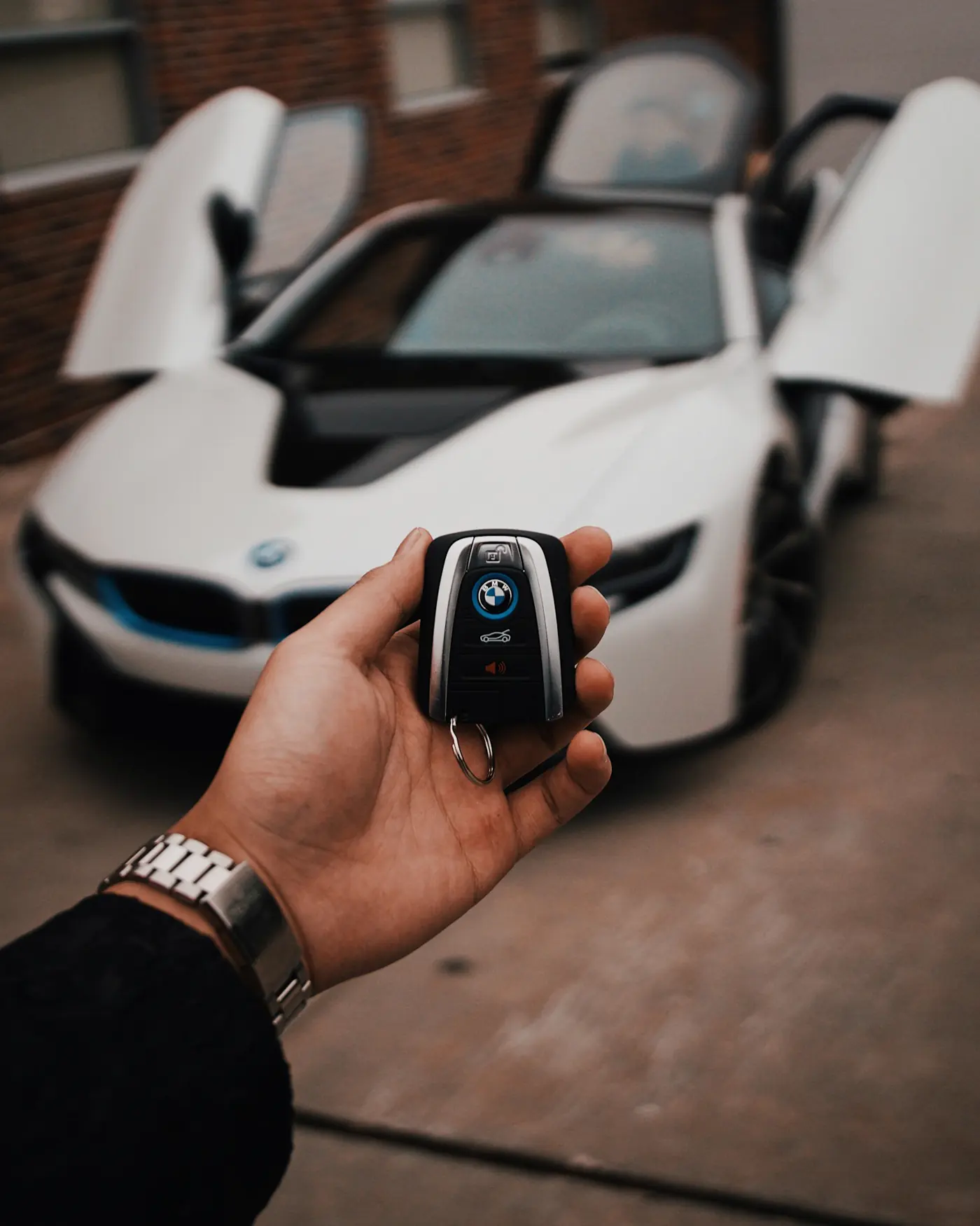 BMW key fob in front of a white vehicle